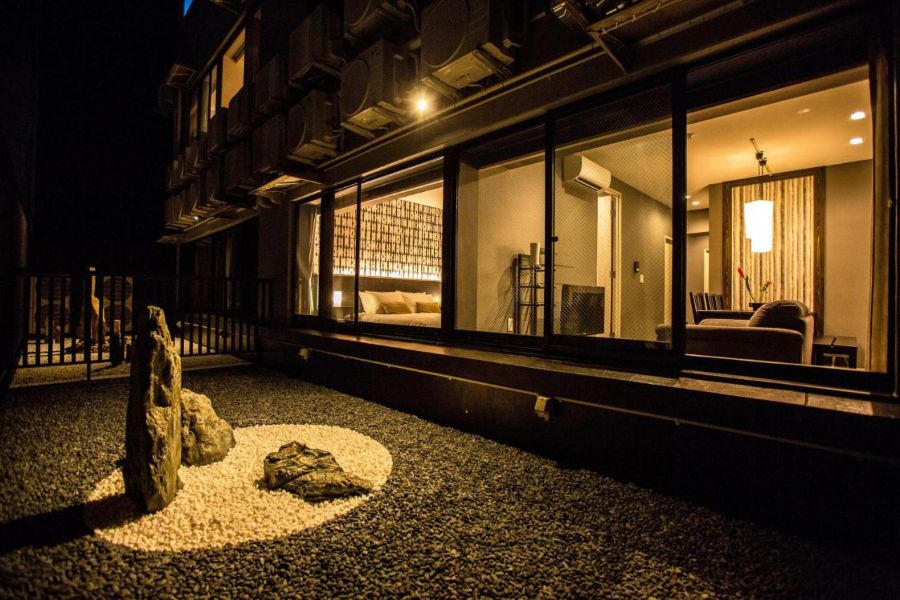R&Run Kyoto Serviced Apartment & Suites at night with living space and bedroom