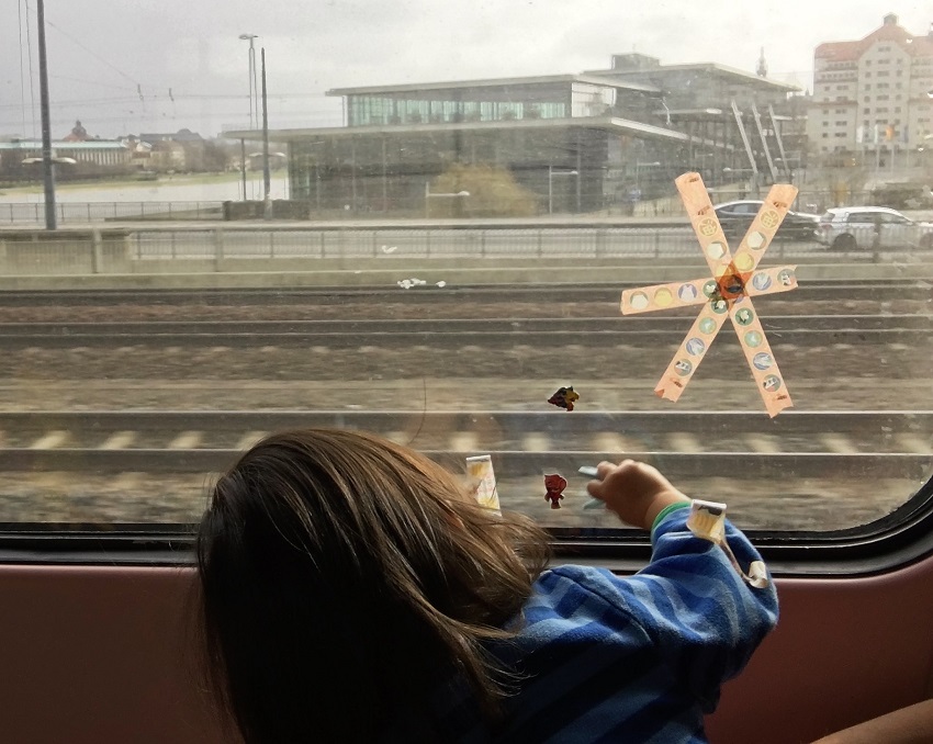 Playing with stickers on a train window