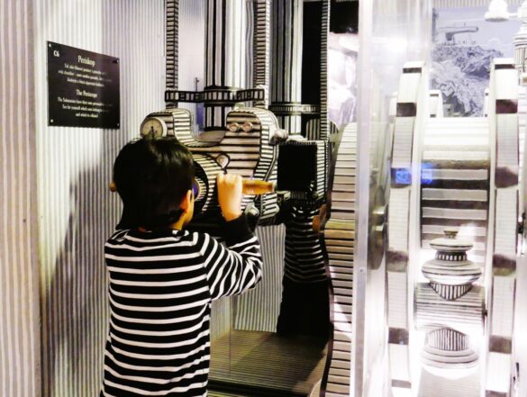Child gazes through a zany periscope at the Karel Zeman Museum Prague - One of the most child-friendly museums in Prague