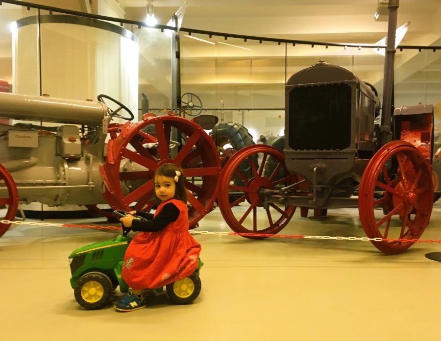 Toddler riding a mini tractor at the National Agricultural Museum Prague - One of the best museums in Prague for families. 