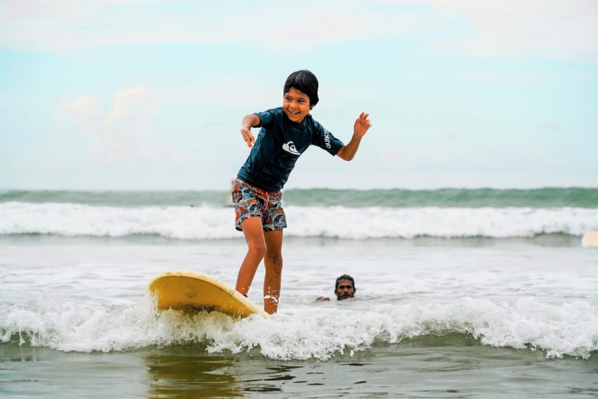Family surfing in Welagama, Sri Lanka