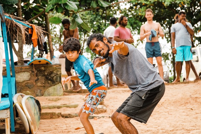 Surf training on the beach, Weligama Bay, Sri Lanka. Family-friendly surfing in Sri Lanka