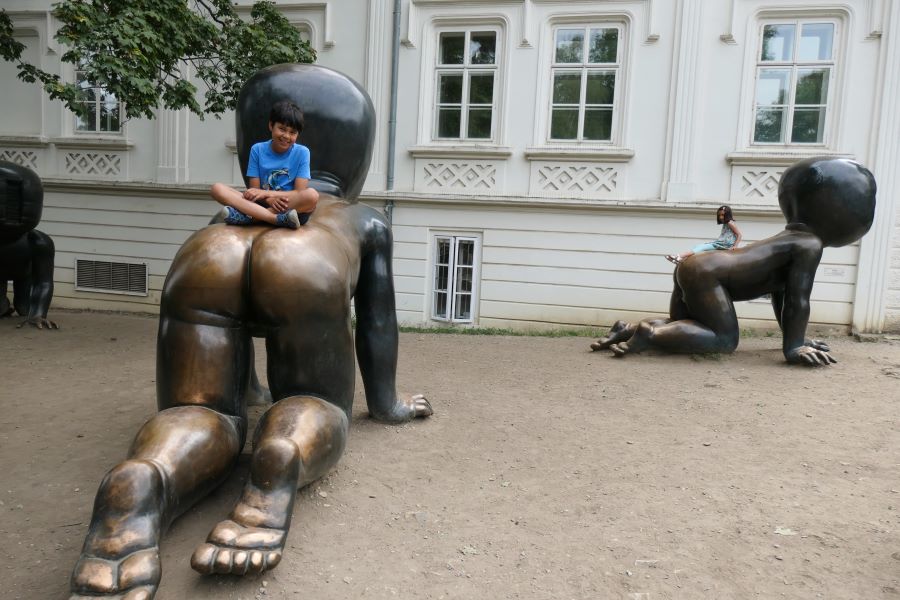 Children climbing the Babies sculpture by Czech artist David Cerny on Kampa island Prague