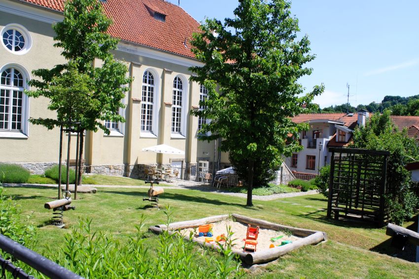Grassy area and sandpit outside the Synagogue cafe in Cesky Krumlov.