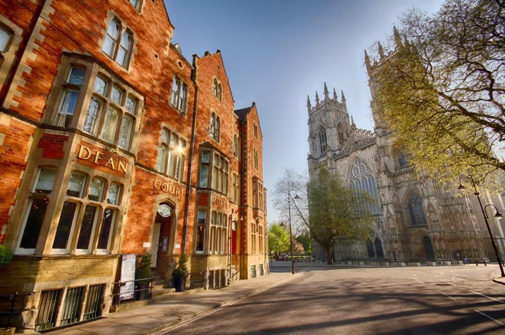 Red brick Dean Court Hotel with bedrooms facing out on the Gothic York Minster in central York